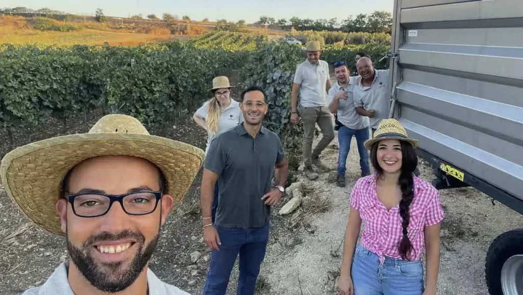 Picture of Mirko Caracci with family and workers on the field